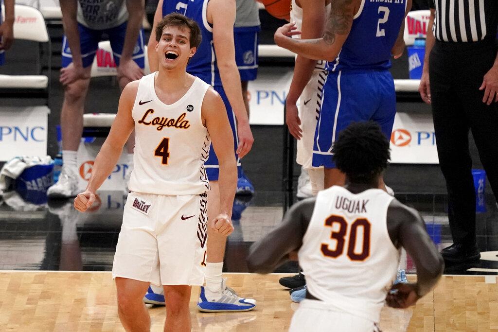 Loyola of Chicago’s Braden Norris (4) and teammate Aher Uguak (30) celebrate a 75-65 victory over Drake during the championship game in the NCAA Missouri Valley Conference men’s basketball tournament Sunday, March 7, 2021, in St. Louis. (AP Photo / Jeff Roberson)
