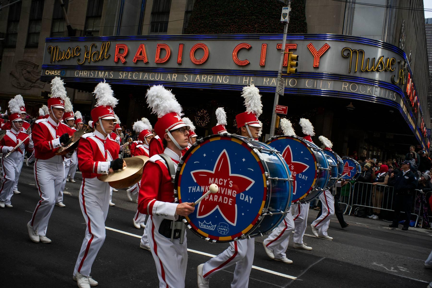 Revelers makes their way down the Avenue of the Americas in front of Radio City Music Hall during the Macy's Thanksgiving Day Parade in New York on Nov. 28, 2019. (AP Photo / Eduardo Munoz Alvarez, File)