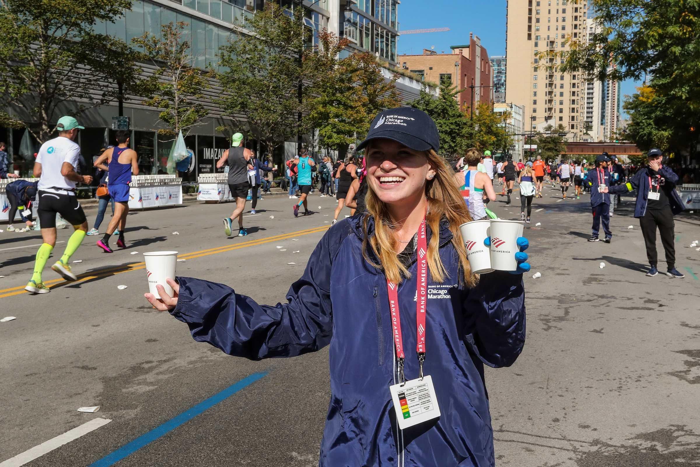 A volunteer hands out water to competitors in 2022. (Kevin Morris / 2022 Bank of America Chicago Marathon)