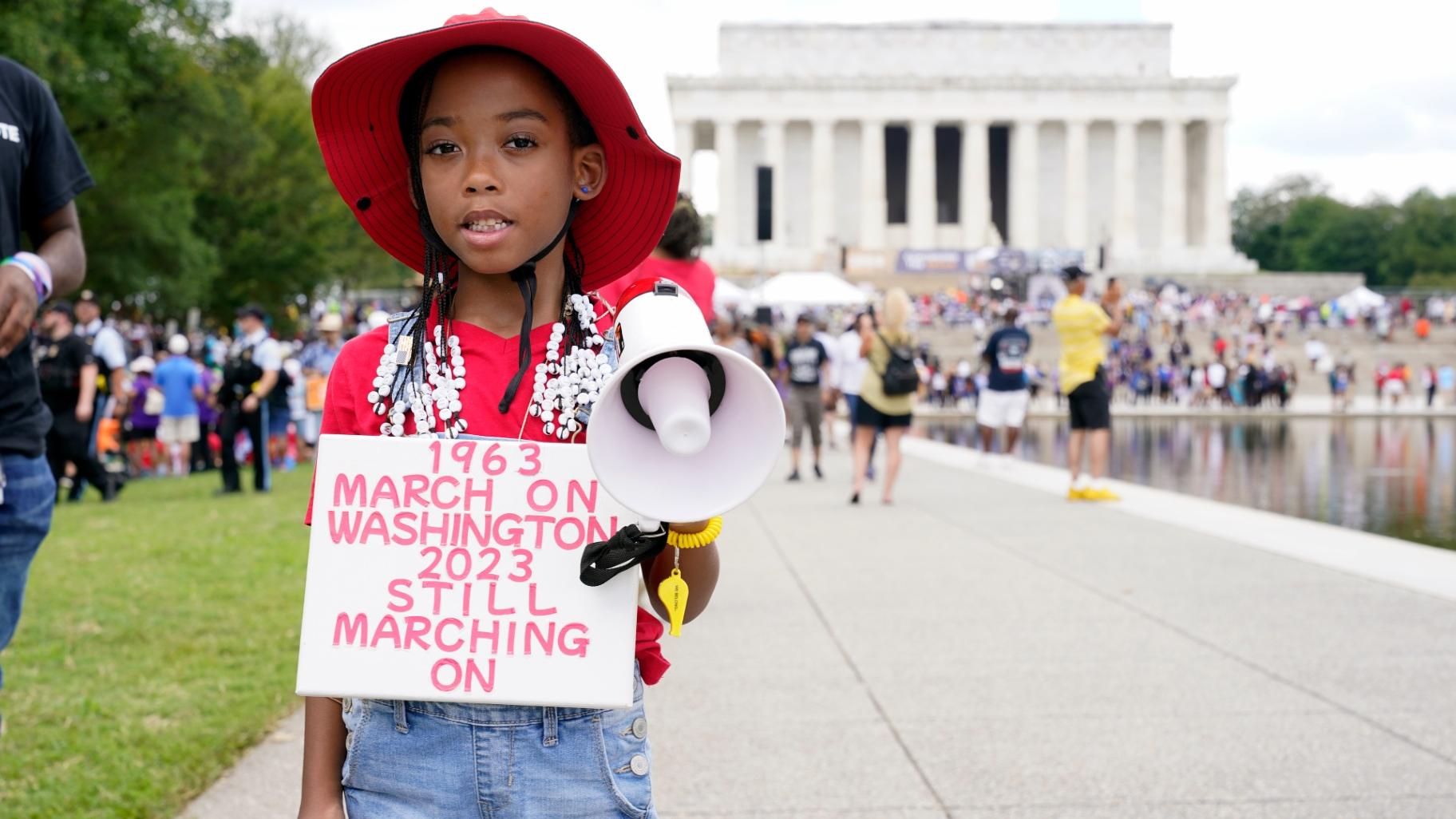 T'Kyrra Terrell, 6, who her grandmother says has been marching and protesting since she was 2, poses for a portrait on her way to the 60th Anniversary of the March on Washington at the Lincoln Memorial, Saturday, Aug. 26, 2023, in Washington. (AP Photo / Jacquelyn Martin)