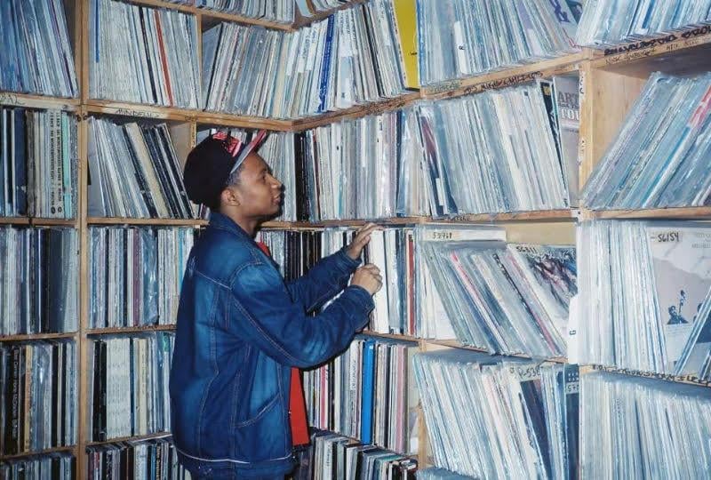 Mario Gage flips through records at the WHPK music library. (Courtesy of Mario Gage) 