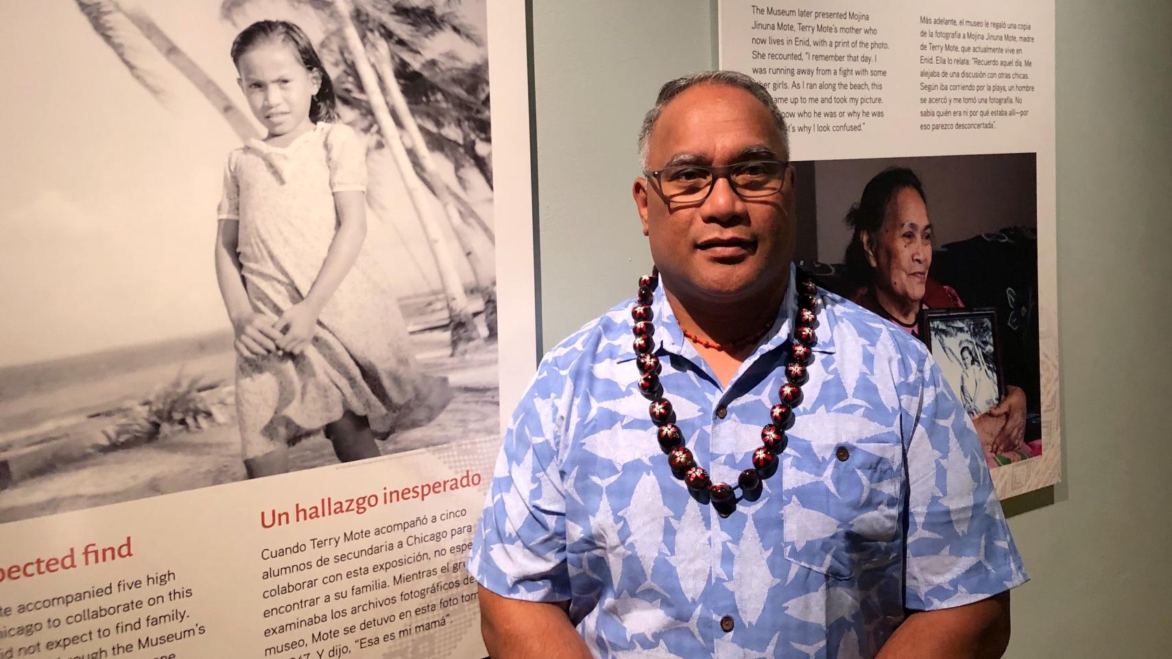 Terry Mote, straddling past and present, as he visits the Field Museum’s exhibit on the Marshall Islands. (Patty Wetli / WTTW News)