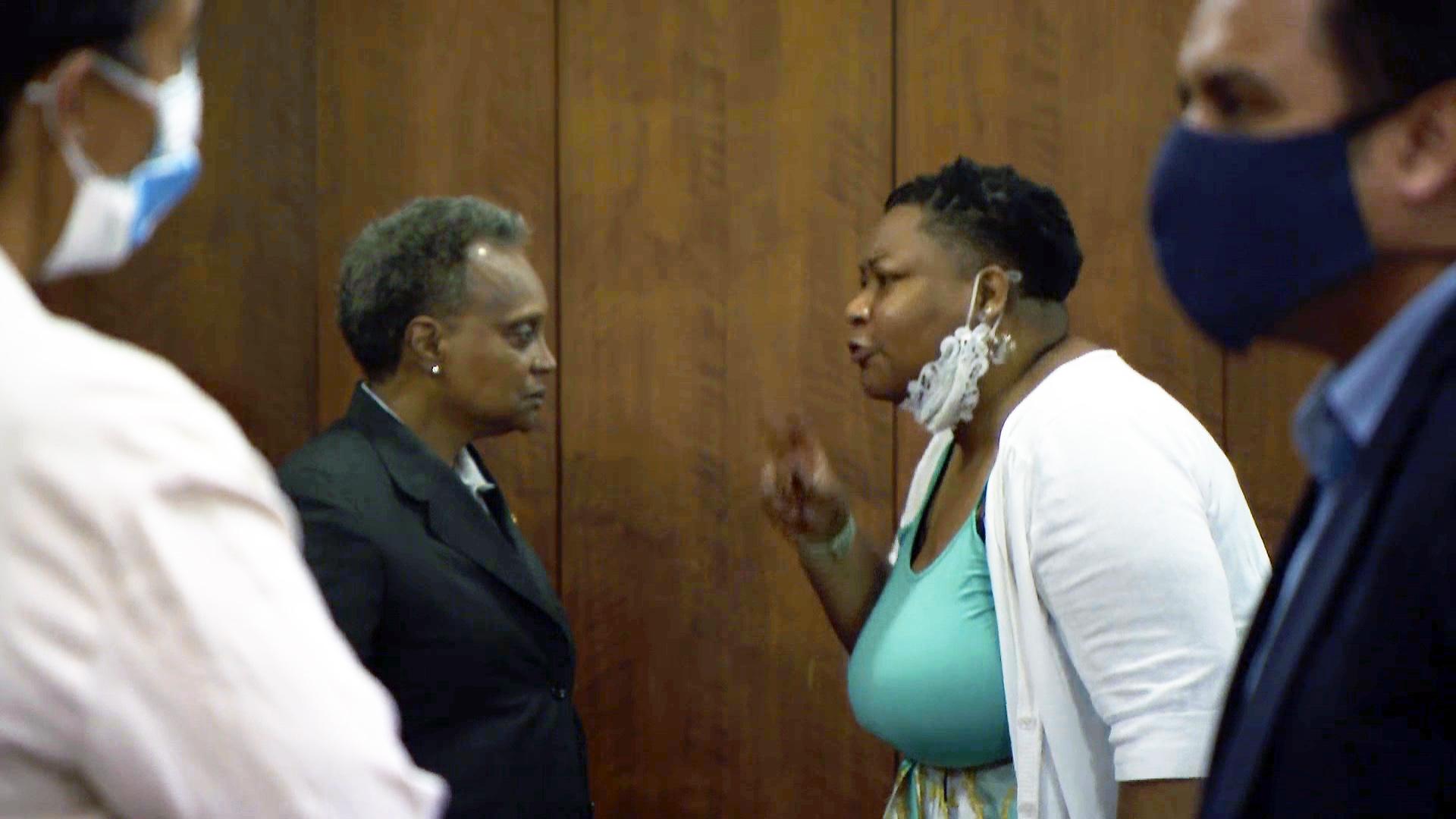 Ald. Jeanette Taylor (20th Ward), left, speaks with Mayor Lori Lightfoot at a City Council meeting Wednesday, June 23, 2021. (WTTW News)