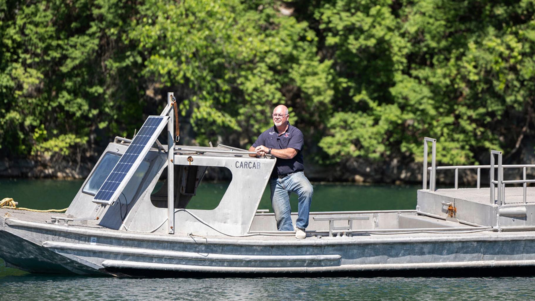 Co-owner of Mermet Springs Glen Faith poses for a portrait on the training boat stationed in the middle of the quarry April 23, 2026, at Mermet Springs in Belknap, Illinois. (Peyton Cook / Saluki Local Reporting Lab)