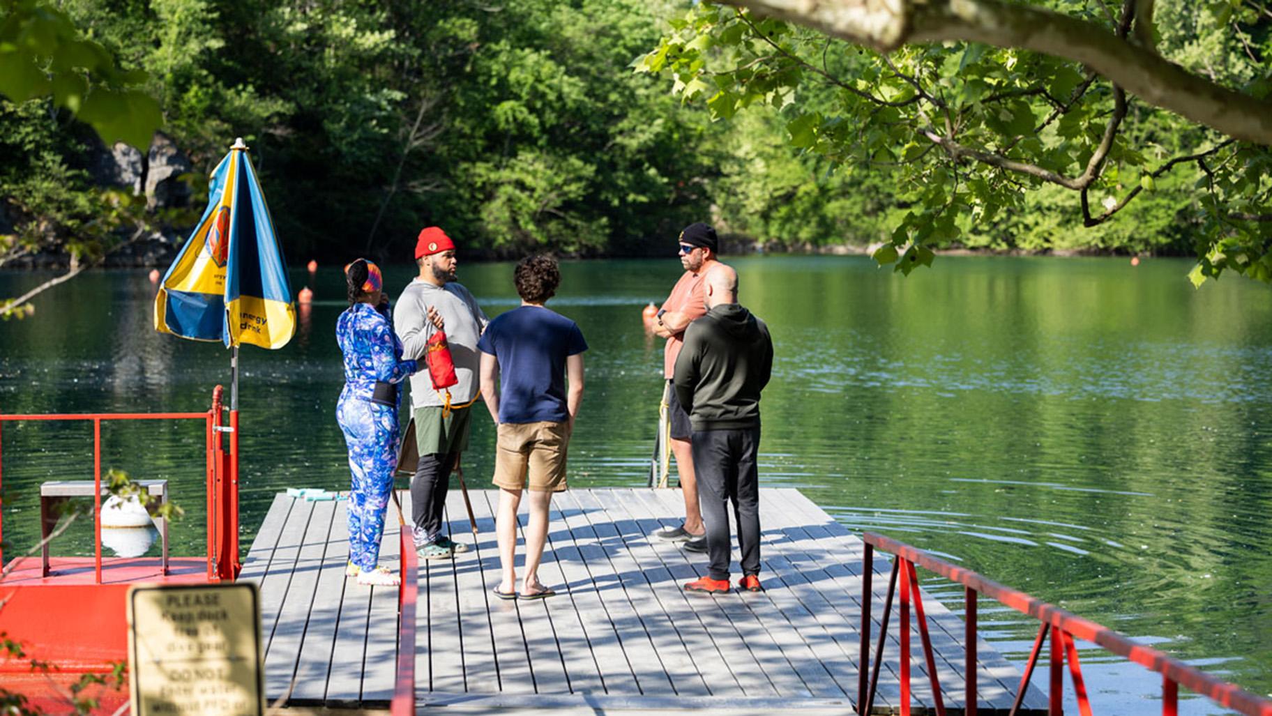 Students and instructors from Louisville dive shop stand together and talk through a dive for an open water class April 25, 2026, at Mermet Springs in Belknap, Illinois. (Peyton Cook / Saluki Local Reporting Lab)