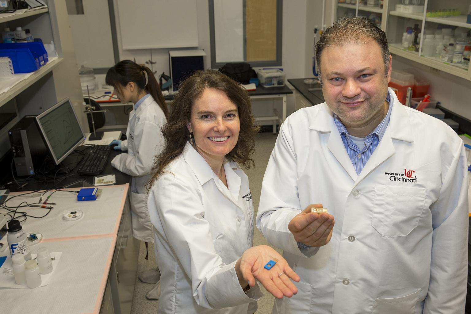 UIC bioengineering professor Ian Papautsky and Erin Haynes of the University of Cincinnati Department of Environmental Health present a sensor that will conduct rapid testing for human exposure to toxic metals. (Courtesy University of Cincinnati)