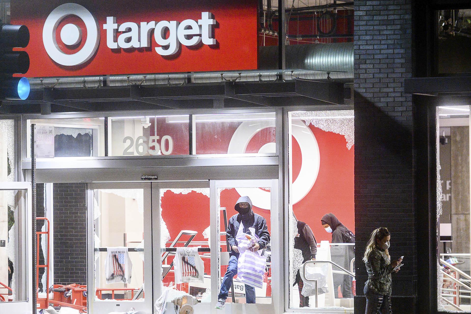 People leave a vandalized Target store in Oakland, Calif., on Saturday, May 30, 2020, during protests against the death of George Floyd, a handcuffed black man in police custody in Minneapolis. (AP Photo / Noah Berger)