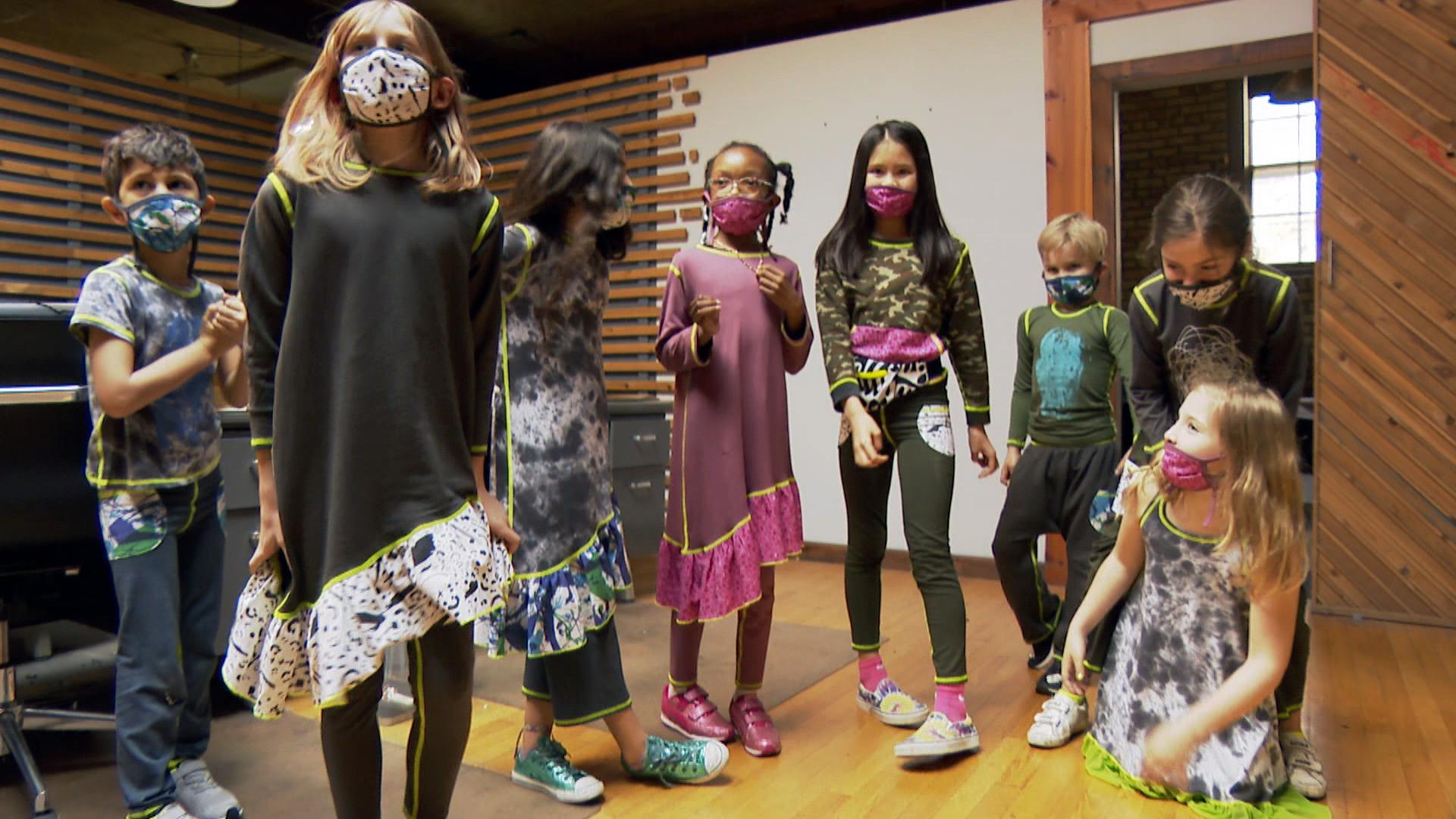 Hannah Lewis, top-right, and her classmates dance while wearing Minor Details clothing at Delicious Design League, a creative studio, on April 15, 2021. (WTTW News)