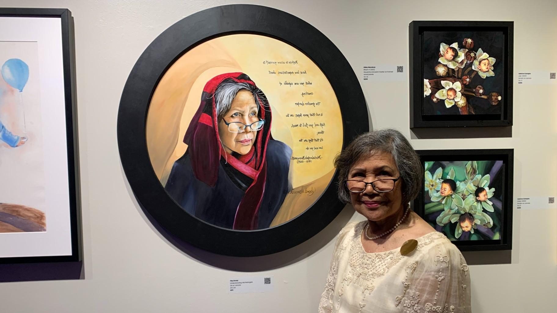 Artist Tita Recometa-Brady’s with her artwork “Understanding Michelangelo” at the “More than Lumpia” art exhibit on Oct. 6 at the Epiphany Center for the Arts. (WTTW News / Eunice Alpasan)