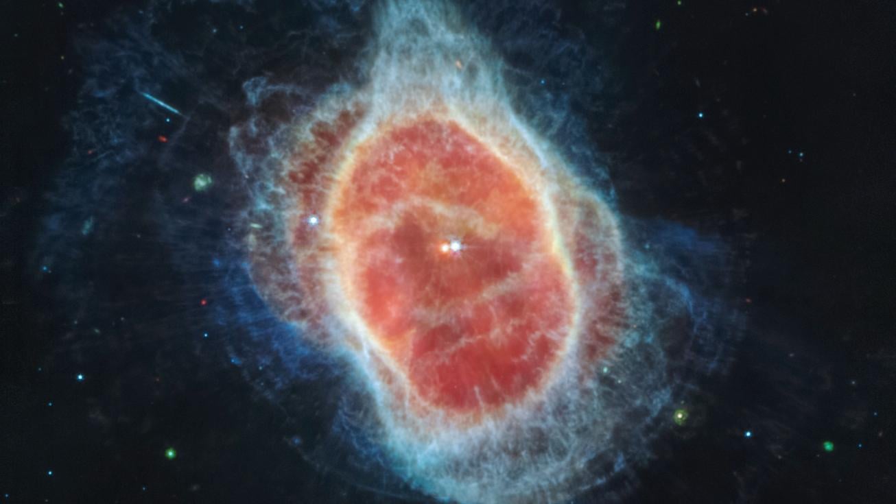This image released by NASA on Tuesday, July 12, 2022, shows the Southern Ring Nebula for the first time in mid-infrared light. It is a hot, dense white dwarf star, according to NASA. (NASA, ESA, CSA, STScI via AP)