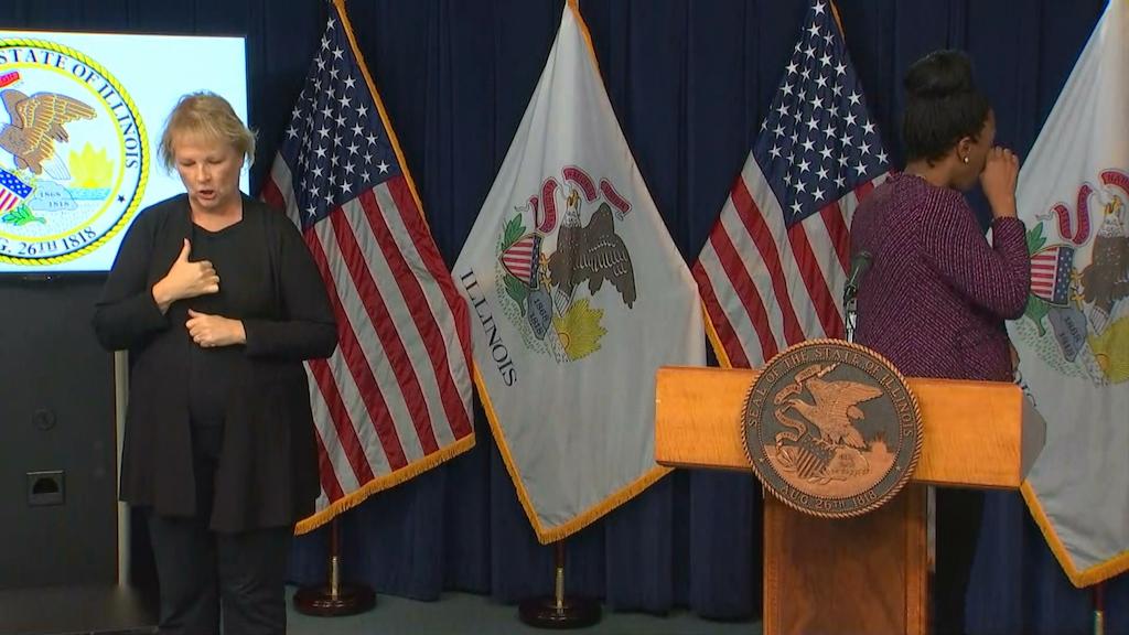 Illinois Department of Public Health Director Dr. Ngozi Ezike, right, begins tearing up after reading the daily COVID-19 case count in Illinois during the Friday, Oct. 23, 2020 press briefing. (WTTW News)