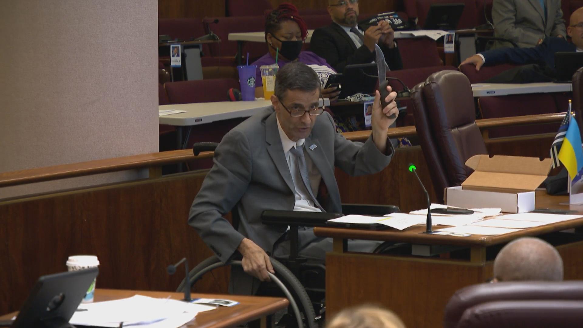 Ald. Nicholas Sposato (38th Ward) holds up a knife during a City Council meeting on Sept. 21, 2022, to explain his vote against a police misconduct settlement. (WTTW News)