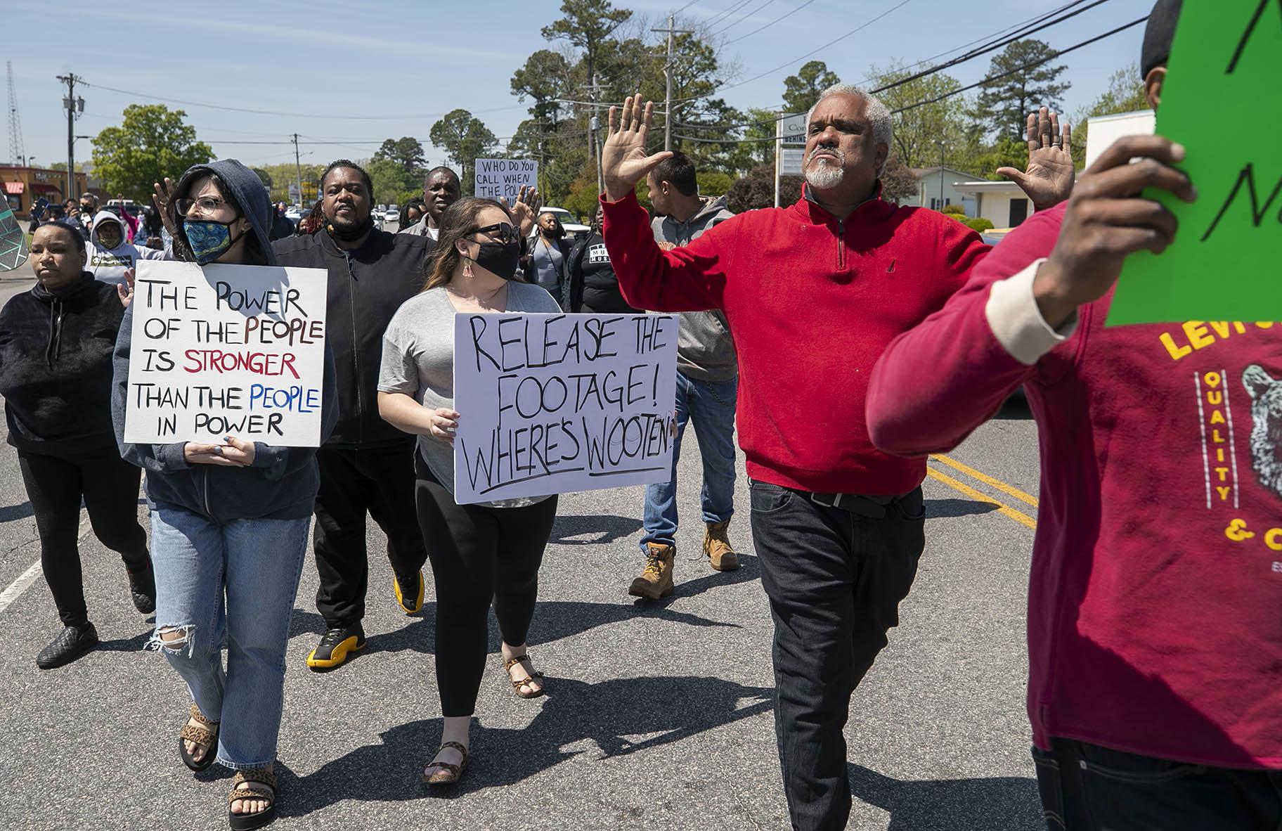 Kirk Rivers leads a group of demonstrators as they block Ehringhaus Street, a main retail avenue in Elizabeth City, N.C., Friday, April 23, 2021, as they demand after a fatal shooting that body camera video be released by the Pasquotank Sheriff’s office. (Robert Willett / The News & Observer via AP)