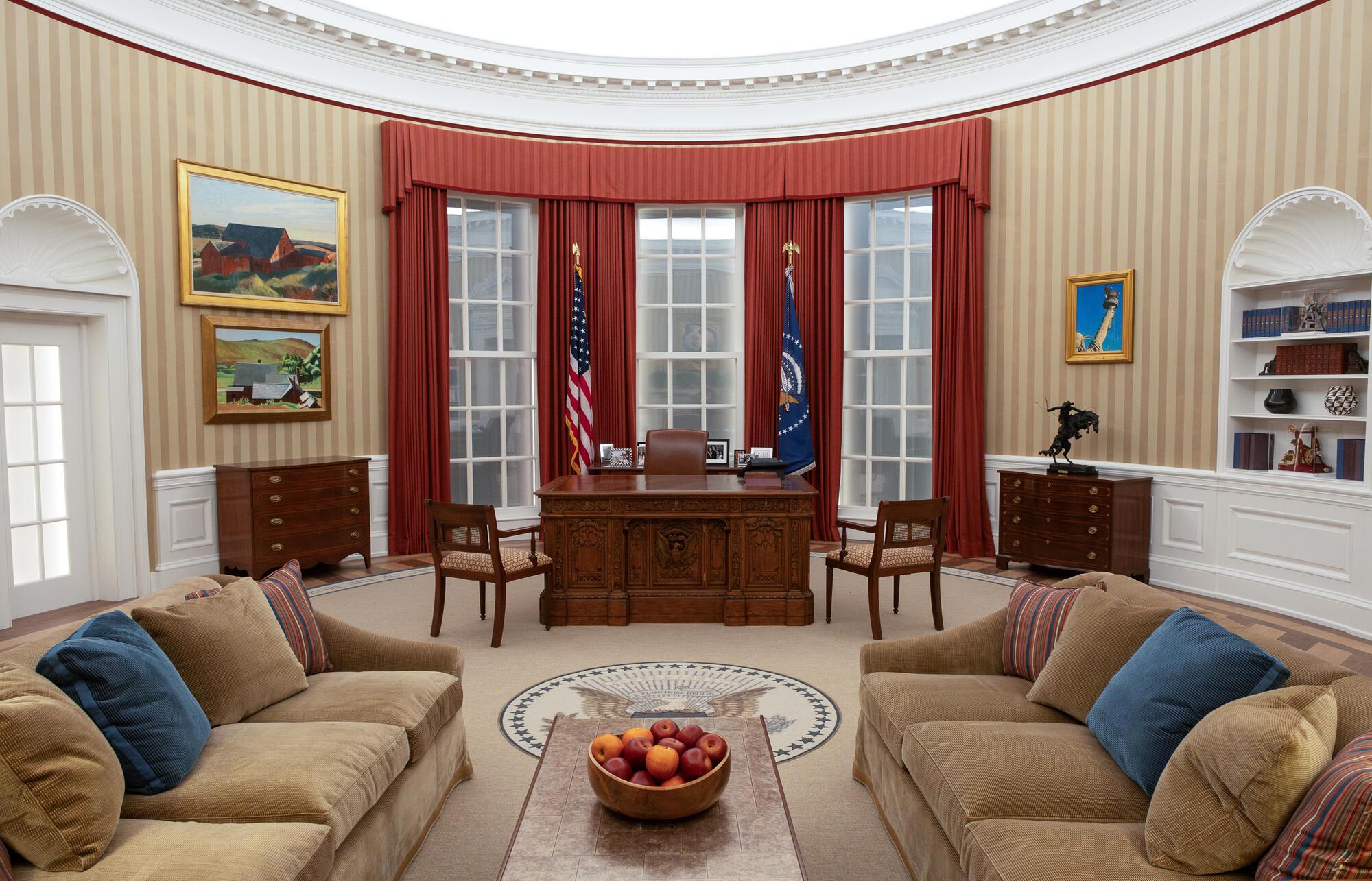 A replica of the Oval Office during Barack Obama’s presidency offers a snapshot in time. Visitors take their turn sitting behind the Resolute Desk. (The Obama Foundation)