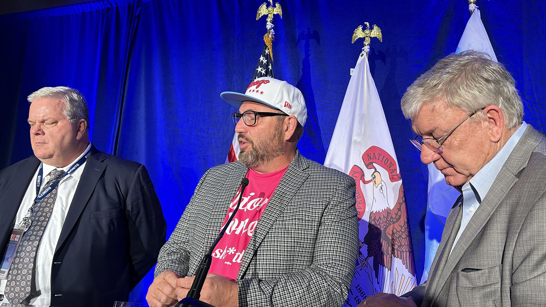 Eric Dean, general president of the International Association of Bridge, Structural, Ornamental & Reinforcing Iron Workers, Bob Reiter, president of the Chicago Federation of Labor, and Tim Drea, president of the Illinois AFL-CIO, speak to Illinois delegates on Aug. 21, 2024. (Blair Paddock / WTTW News)