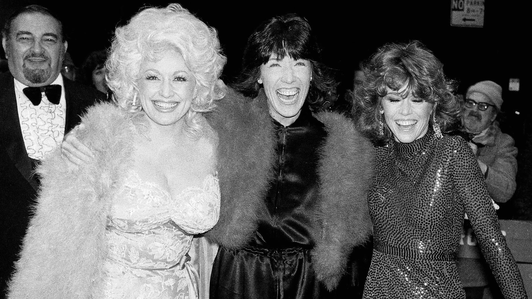 FILE - Dolly Parton, left, Lily Tomlin, center, and Jan Fonda arrive for the premiere of their film "9 To 5" in New York on Dec. 14, 1980. (AP Photo / Richard Drew, File)