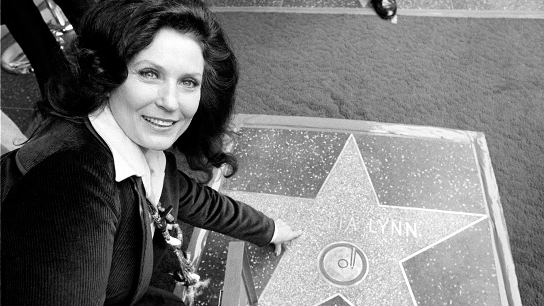 Country music singer Loretta Lynn points to her Hollywood Walk of Fame star during induction ceremonies in Hollywood, Calif., on Feb. 8, 1978. (AP Photo / File)