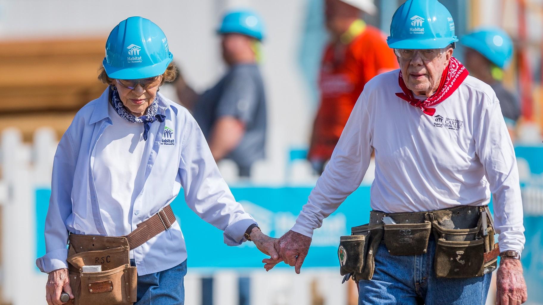 Former President Jimmy Carter, right, holds hands with his wife, former first lady Rosalynn Carter, as they work with other volunteers on site, Aug. 27, 2018, in Mishawaka, Ind.(Robert Franklin / South Bend Tribune via AP, File)