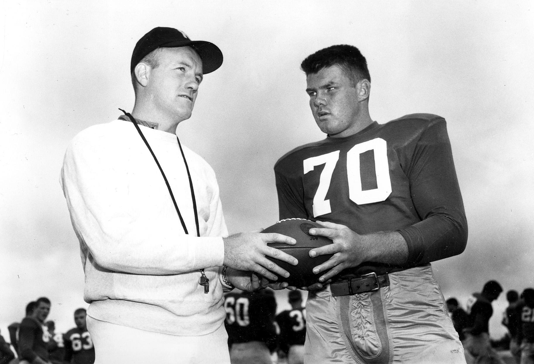 In this September 1958 file photo, Notre Dame football coach Terry Brennan, left, talks with tackle Bronko Nagurski Jr. during practice in South Bend, Ind. (AP Photo, File)