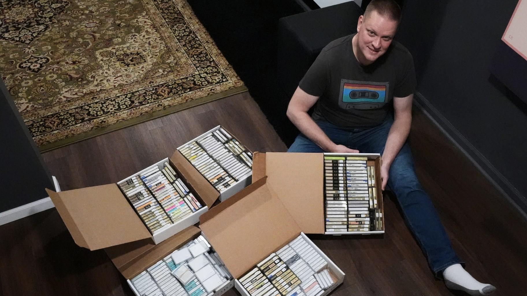 Brian Emerick poses with his recorded tapes for a photo at his home in Des Plaines, Ill., Thursday, March 19, 2026. (AP Photo / Nam Y. Huh)
