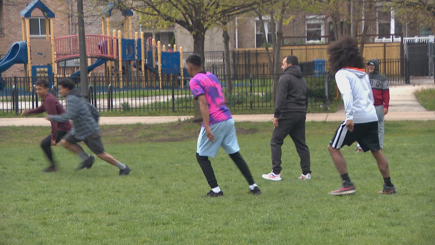 A group of asylum seekers plays soccer outside of the former Wadsworth Elementary School on April 25, 2023. (WTTW News)