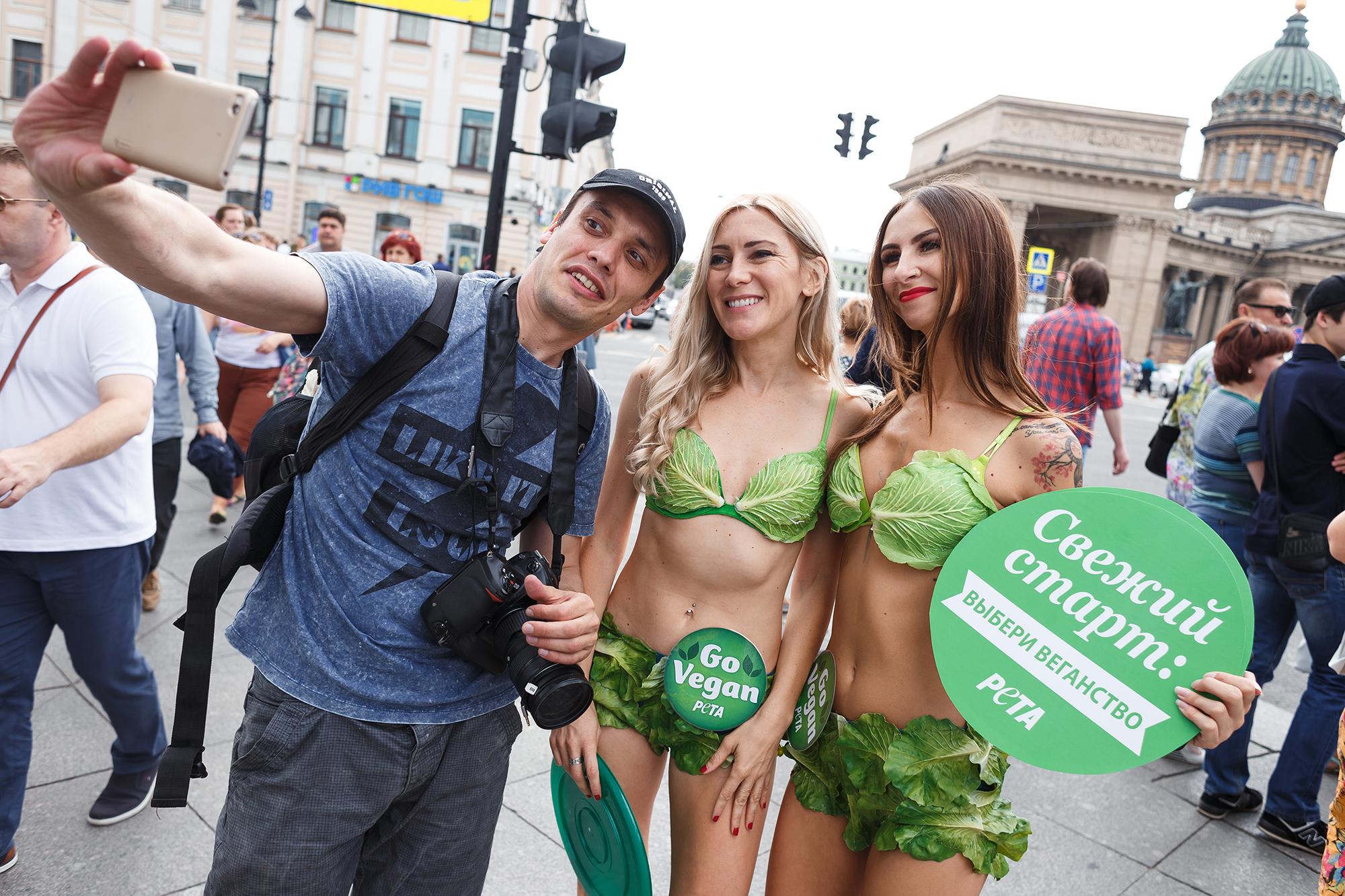 South Elgin native Mysti Lee, right, poses with a passerby while campaigning for PETA in St. Petersburg, Russia. (Dmitry Korotkov / PETA)