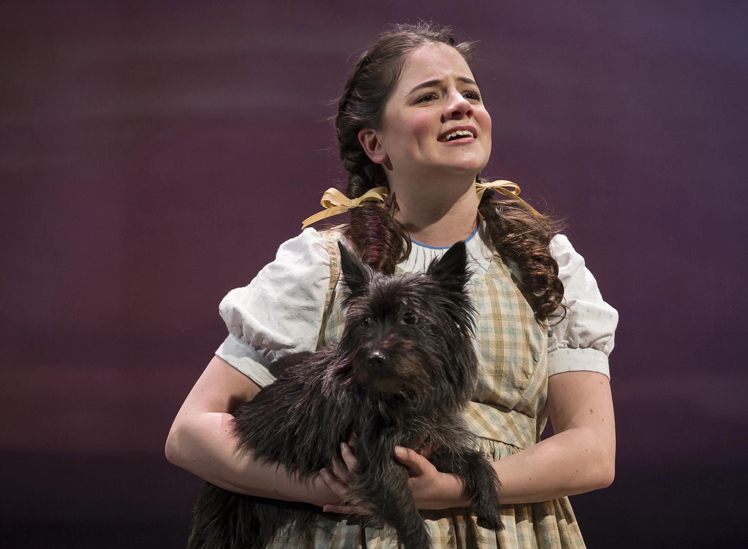 Elizabeth Stenholt as Dorothy and Nessa as Toto in “The Wizard of Oz.” (Photo credit: Liz Lauren)