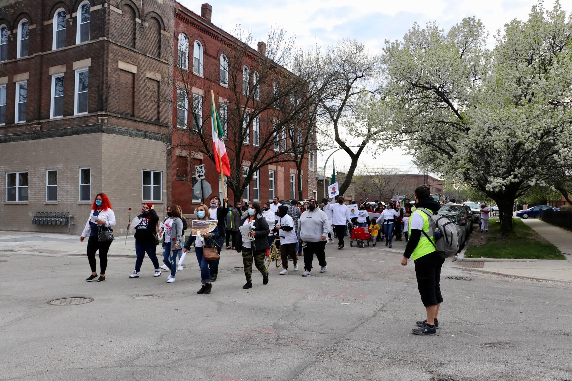 Demonstrators march through the Little Village neighborhood during a peace walk on April 18, 2021. (Evan Garcia / WTTW News)