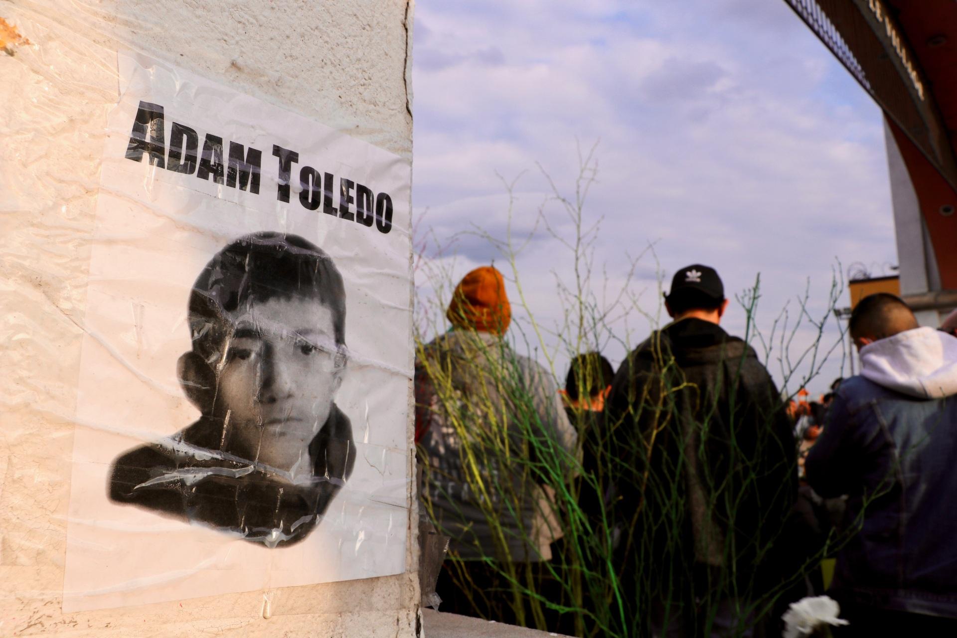 A photo of 13-year-old Adam Toledo taped to the Little Village arch during the April 18, 2021 peace walk. Toledo was fatally shot by a police officer on March 29, 2021. (Evan Garcia / WTTW News)