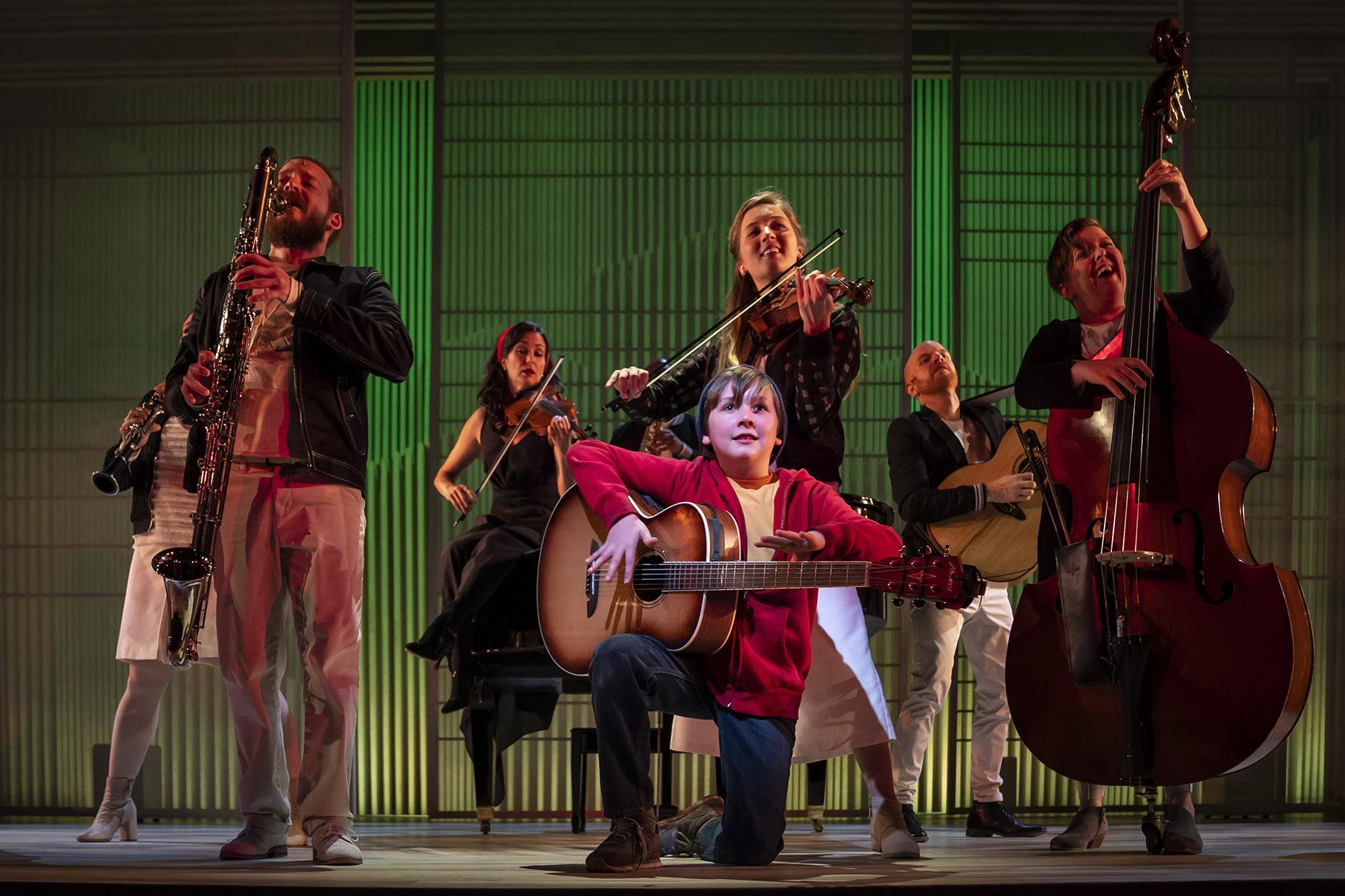 Jack McCarthy, center, plays August Rush/Evan Taylor in Paramount Theatre’s world premiere of “August Rush: The Musical.” (Photo credit: Liz Lauren)