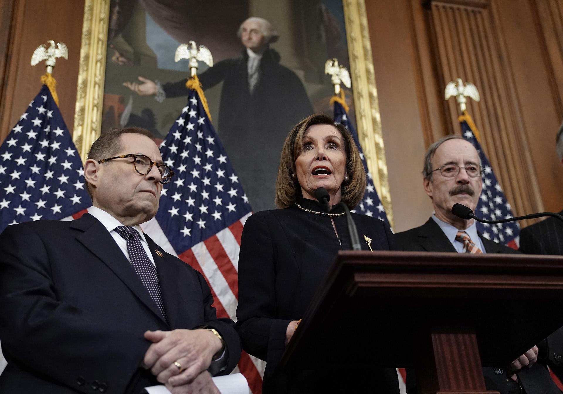 Speaker of the House Nancy Pelosi, D-Calif., flanked by House Judiciary Committee Chairman Jerrold Nadler, D-N.Y., left, and House Foreign Affairs Committee Chairman Eliot Engel, D-N.Y., speaks to reporters at the Capitol in Washington, Wednesday, Dec. 18, 2019, after the House of Representatives voted to impeach President Donald Trump on two charges, abuse of power and obstruction of Congress. (AP Photo / J. Scott Applewhite)