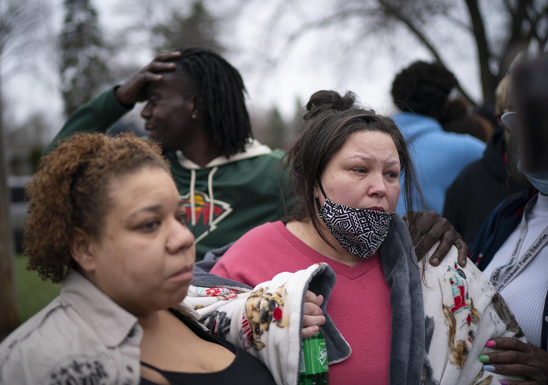 Friends and family comfort Katie Wright, right, while she speaks briefly to news media near where the family says her son Daunte Wright, 20, was shot and killed by police Sunday, April 11, 2021, in Brooklyn Center, Minn. (Jeff Wheeler / Star Tribune via AP)