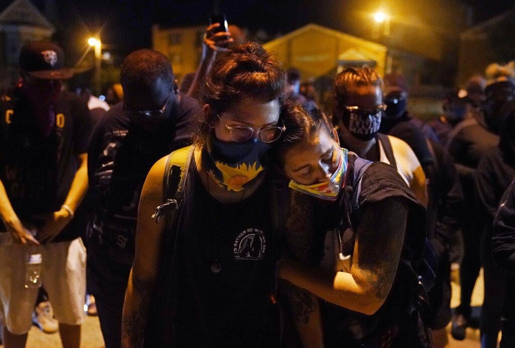 Protesters observe a moment of silence while marching Wednesday night, Aug. 26, 2020, in Kenosha, Wis., near the scene of a fatal shooting Tuesday night. (AP Photo / David Goldman)