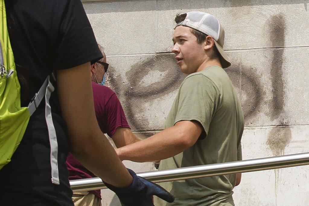 Kyle Rittenhouse helps clean the exterior of Reuther Central High School in Kenosha, Wis., on Tuesday, Aug. 25, 2020. Rittenhouse, 17, was arrested Wednesday, Aug. 26, after two people were shot to death during protests in Kenosha over the police shooting of Jacob Blake. (Pat Nabong / Chicago Sun-Times via AP)