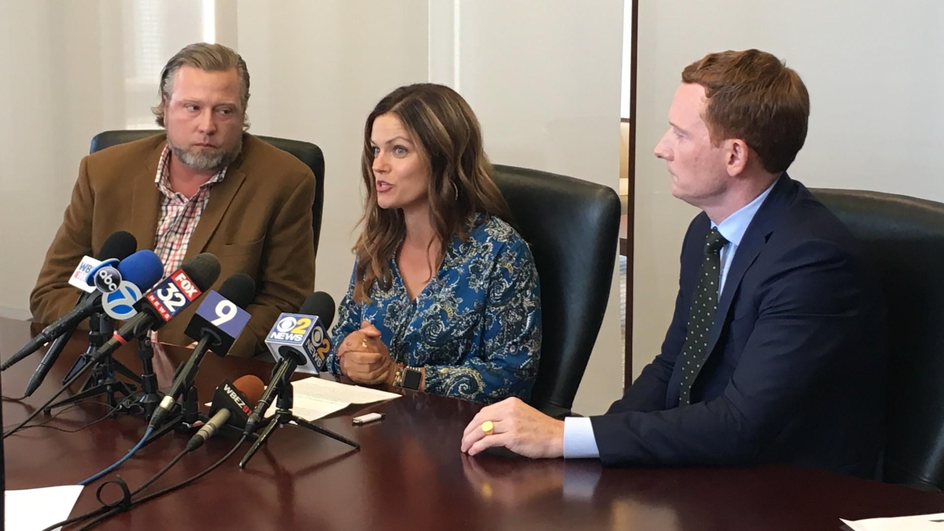 New Lenox residents Tim and Ruby Johnson, left, speak at a press conference Thursday about the recent hospitalization of their daughter, Piper, with their attorney Michael Gallagher, right. (Kristen Thometz / WTTW News)