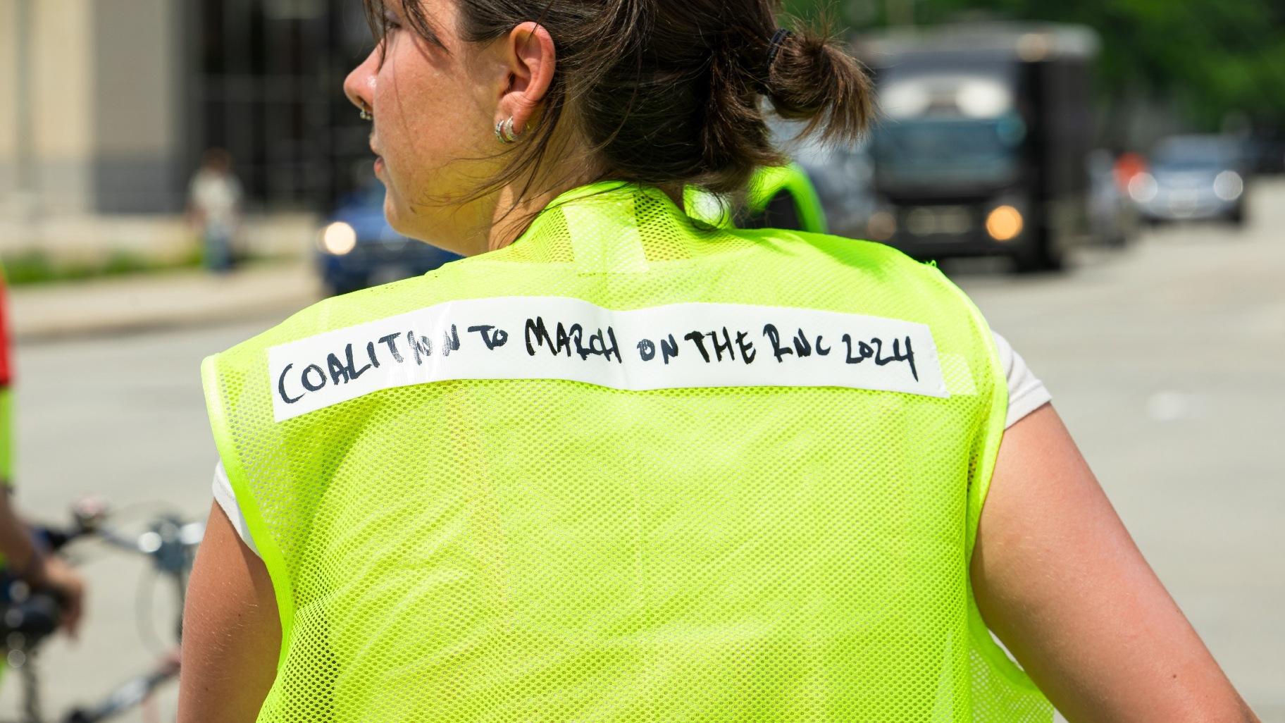 An organizer wears a safety vest that reads the “Coalition to March on the RNC 2024” on Monday, July 15, 2024. (Michael Izquierdo / WTTW News)