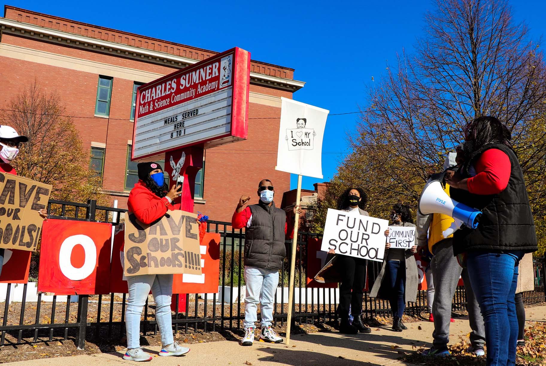 Protesters stand outside Charles Sumner Math and Science Community Academy on Saturday, Oct. 31, 2020. (Grace Del Vecchio / WTTW News)