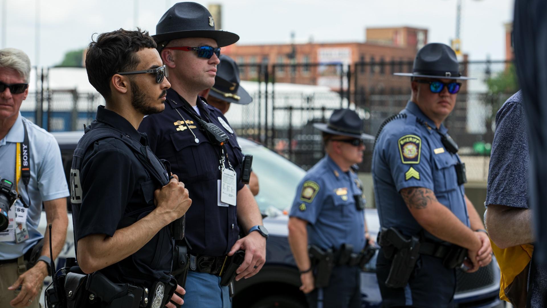 Police officers stand watch during a protest march through Milwaukee during the Republican National Convention on July 15, 2024. (Michael Izquierdo / WTTW News)