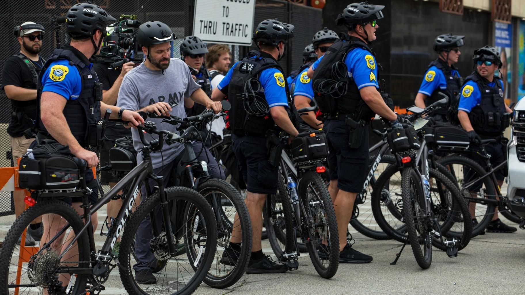 Police officers stand watch during a protest march through Milwaukee during the Republican National Convention on July 15, 2024. (Michael Izquierdo / WTTW News)