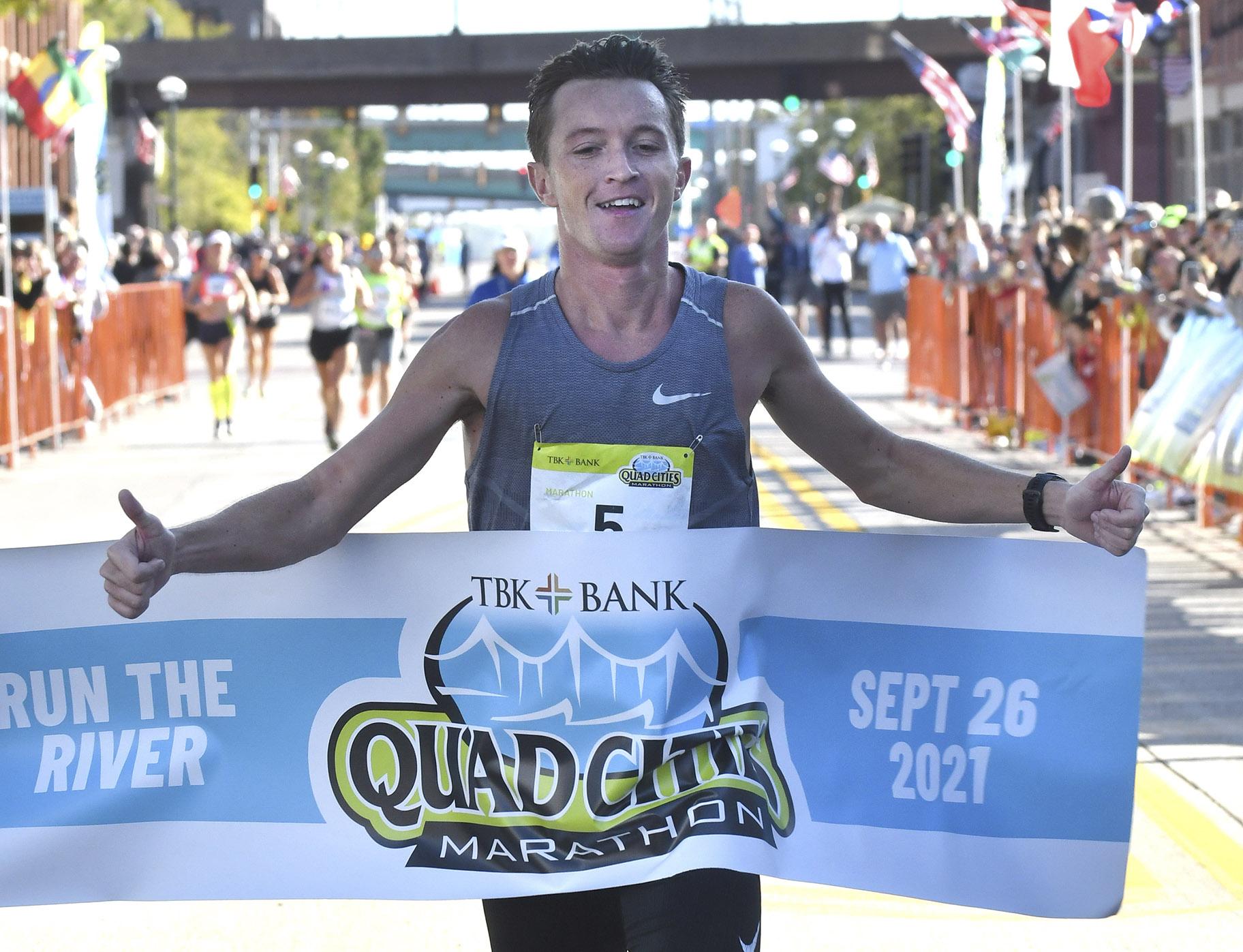 Tyler Pence of Springfield, Ill., finishes first in the TBK Bank Quad Cities Marathon on Sunday, Sept. 26, 2021, in Moline, Ill. (Gary L. Krambeck / Quad City Times via AP)