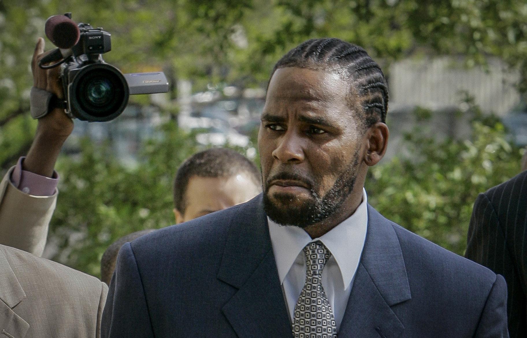 This photo from Friday May 9, 2008, shows R. Kelly arriving for the first day of jury selection in his child pornography trial at the Cook County Criminal Courthouse in Chicago. (AP Photo / Charles Rex Arbogast, File)