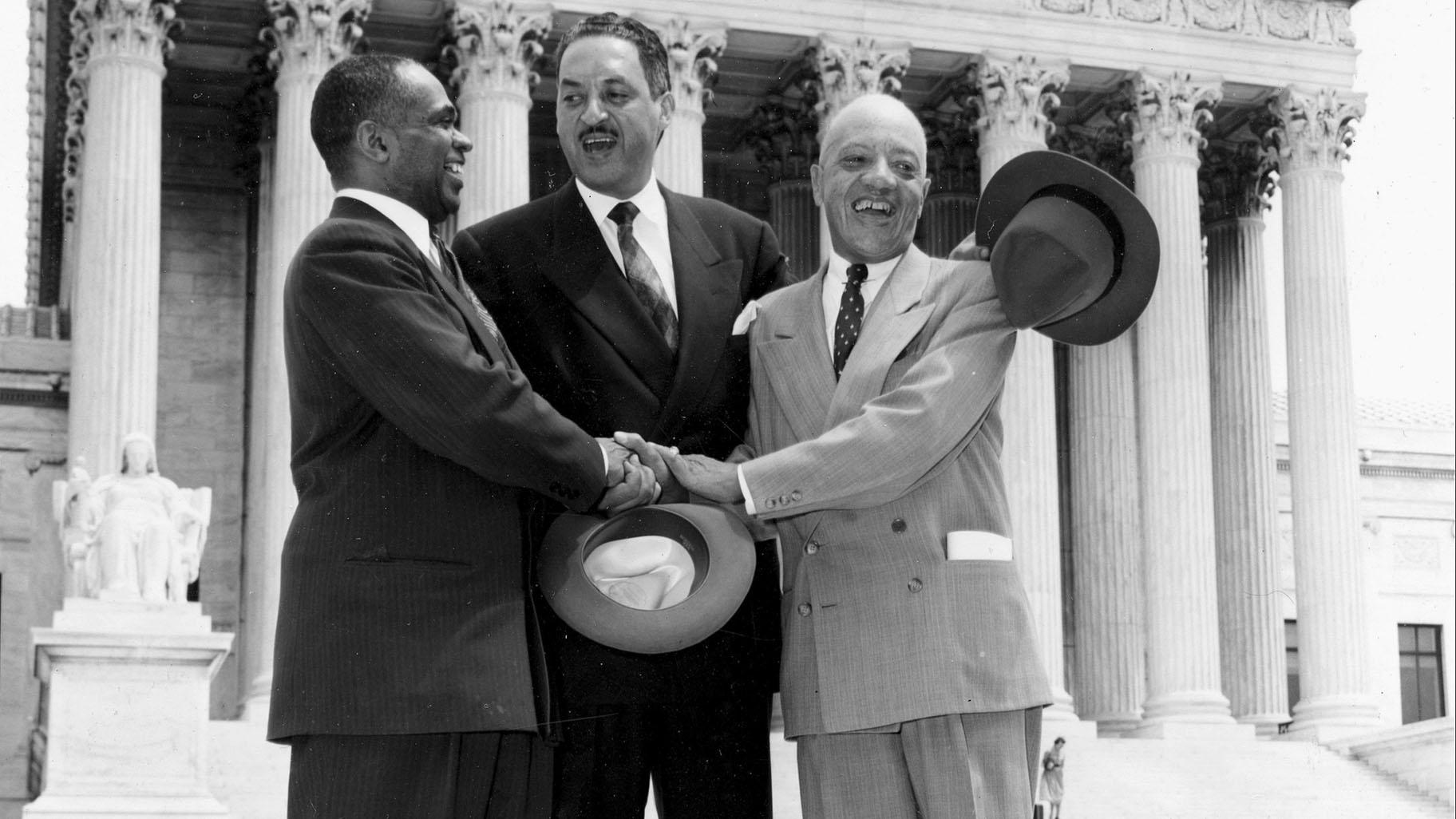 George E.C. Hayes, from left, Thurgood Marshall and James M. Nabrit join hands as they pose outside the Supreme Court in Washington on May 17, 1954. The three lawyers led the fight for abolition of segregation in public schools before the Supreme Court, which ruled that segregation is unconstitutional. (AP Photo, File)