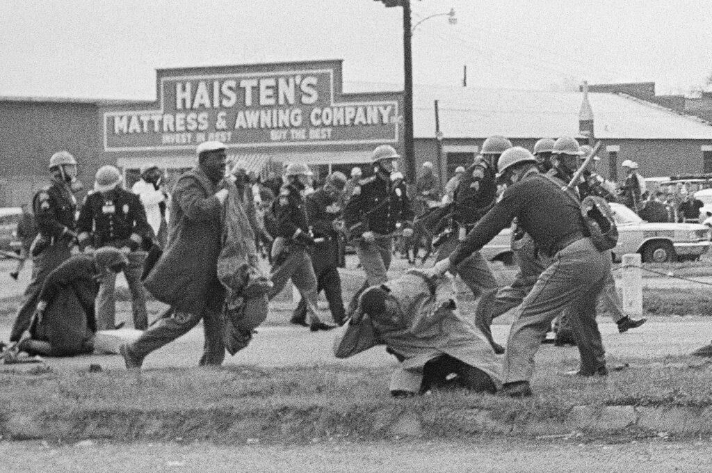 In this March 7, 1965, file photo, a state trooper swings a billy club at John Lewis, right foreground, chairman of the Student Nonviolent Coordinating Committee, to break up a civil rights voting march in Selma, Ala. (AP Photo / File)