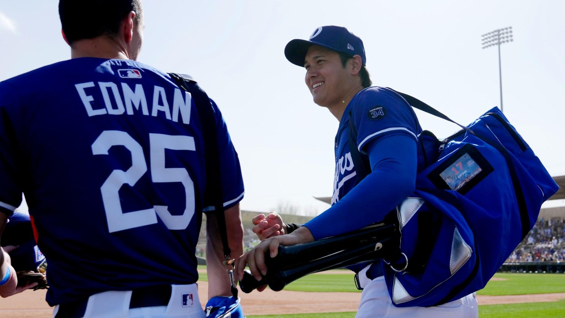 Los Angeles Dodgers' Shohei Ohtani, right, of Japan, smiles as he leaves the game with Dodgers' Tommy Edman (25) during the sixth inning of a spring training baseball game against the Texas Rangers Thursday, March 6, 2025, in Phoenix. (AP Photo / Ross D. Franklin)