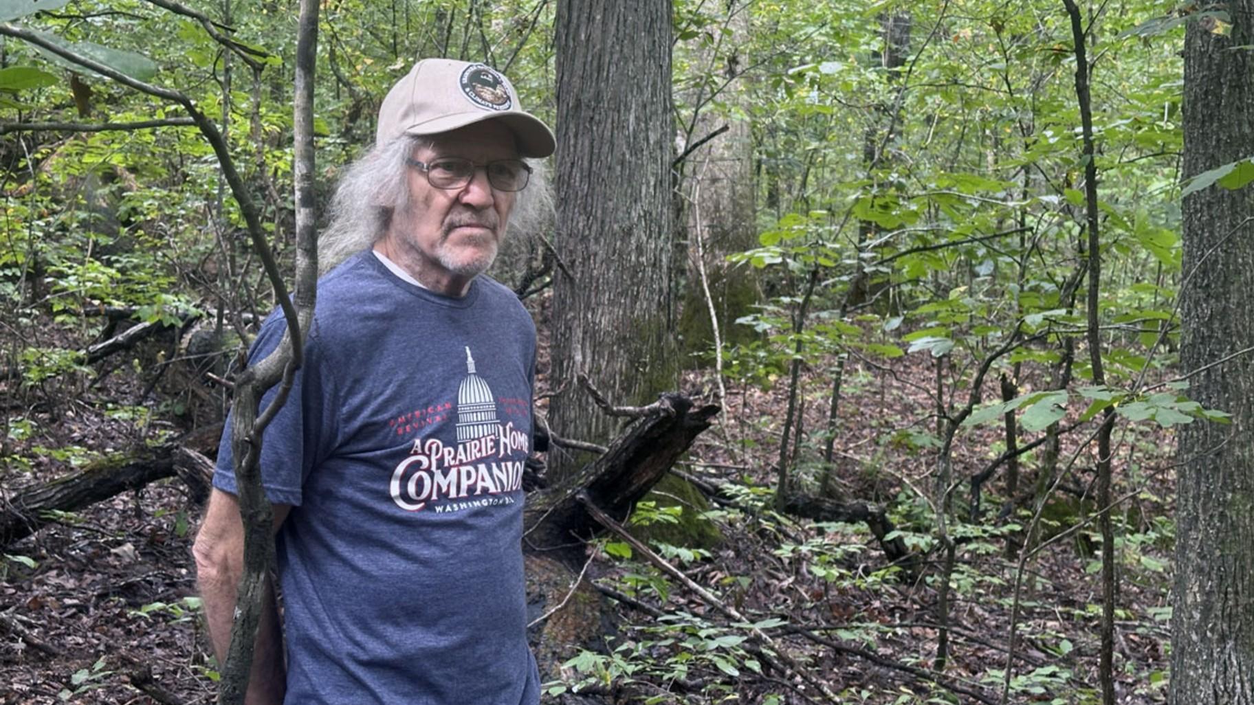 Shawnee conservation activist Mark Donham, 73, of Brookport, hikes within the Burke Branch area of the Shawnee. The protected area backs up to Donham’s 13-acre property, where he has lived since 1980. (Kate McCann / Capitol News Illinois)