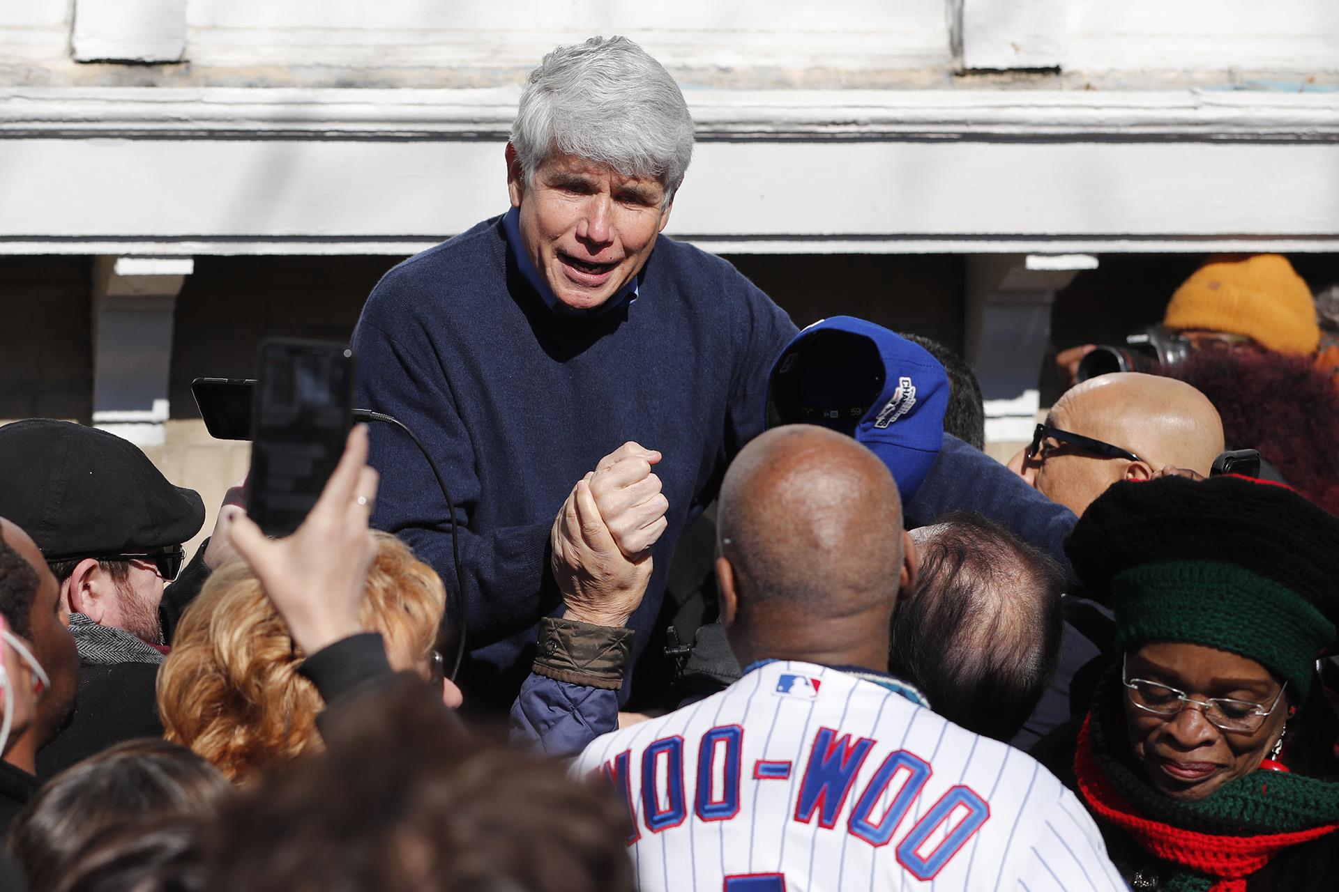 Former Illinois Gov. Rod Blagojevich acknowledges Chicago Cubs’ fan Ronnie Woo Woo after a news conference outside his home Wednesday, Feb. 19, 2020, in Chicago. (AP Photo / Charles Rex Arbogast)