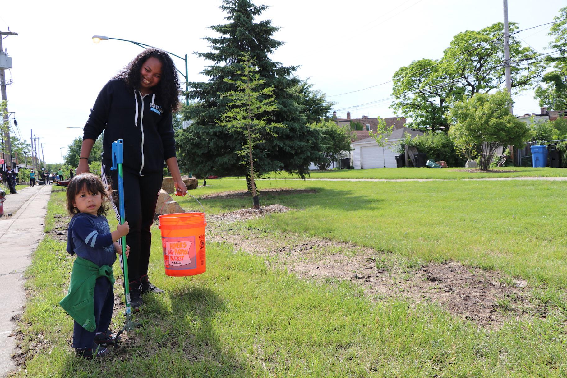 Volunteer Meia Santos and her son Arlo Garcia pick up litter at the event. (Evan Garcia / WTTW)