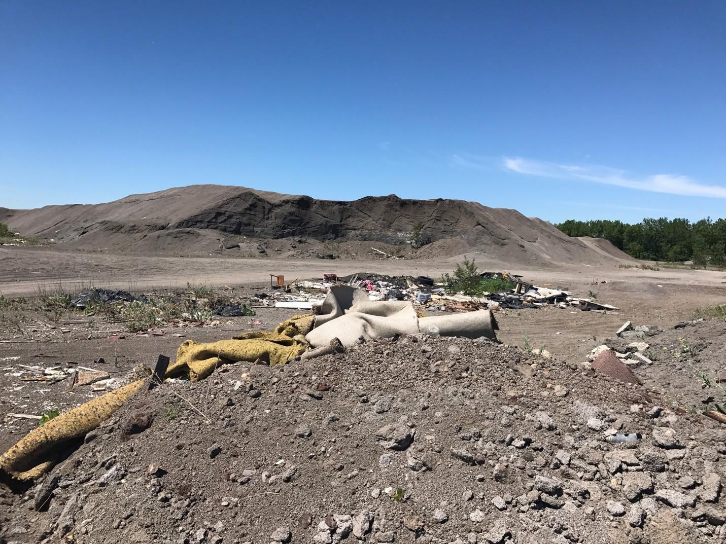 Clusters of trash in front of a slag pile at the Schroud site, a former dumping ground for Republic Steel’s Chicago plant. (Courtesy Chicago Legal Clinic) 