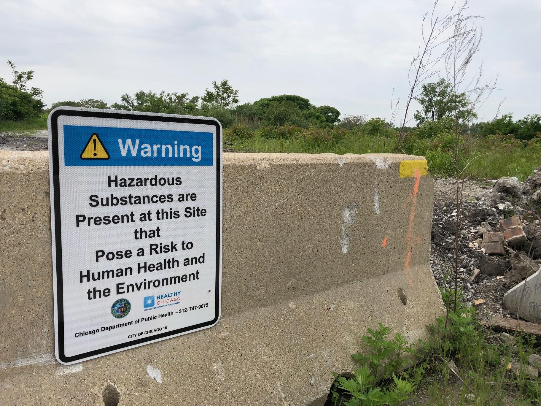 A Chicago Department of Public Health sign warns passersby about hazardous materials at the 67-acre property west of Wolf Lake at 126th Place and Avenue O. (Alex Ruppenthal / WTTW News)