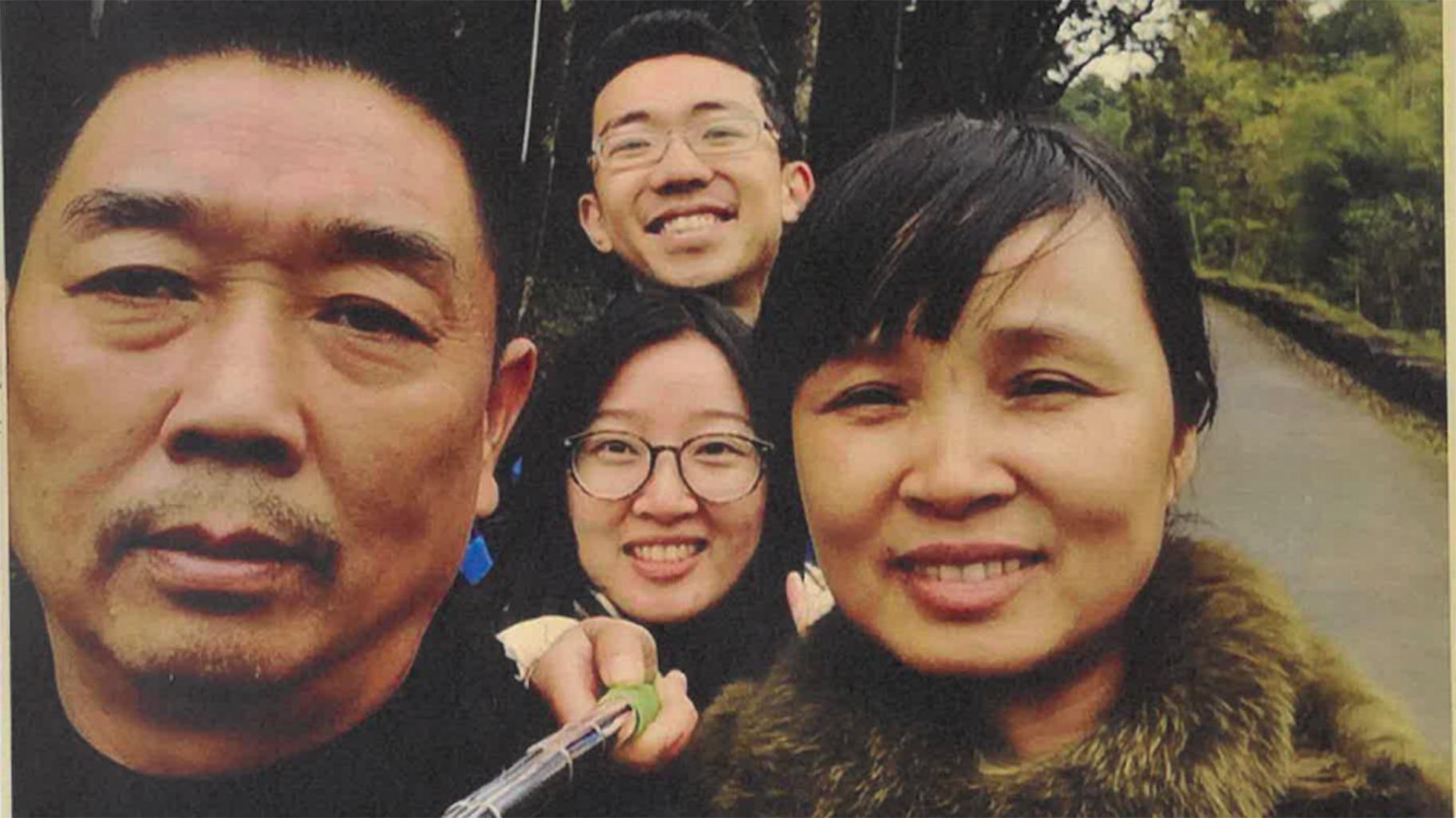 Yingying Zhang, center, takes a photo with her father Ronggao Zhang, left, mother Lifeng Ye and fiance Xiaolin Hou. (U.S. Attorney's Office)